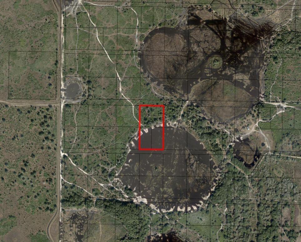 This is an aerial map showing a rectangular property parcel highlighted in red near wetlands — 0 302nd Street, Okeechobee FL 34972, OKEECHOBEE, FL