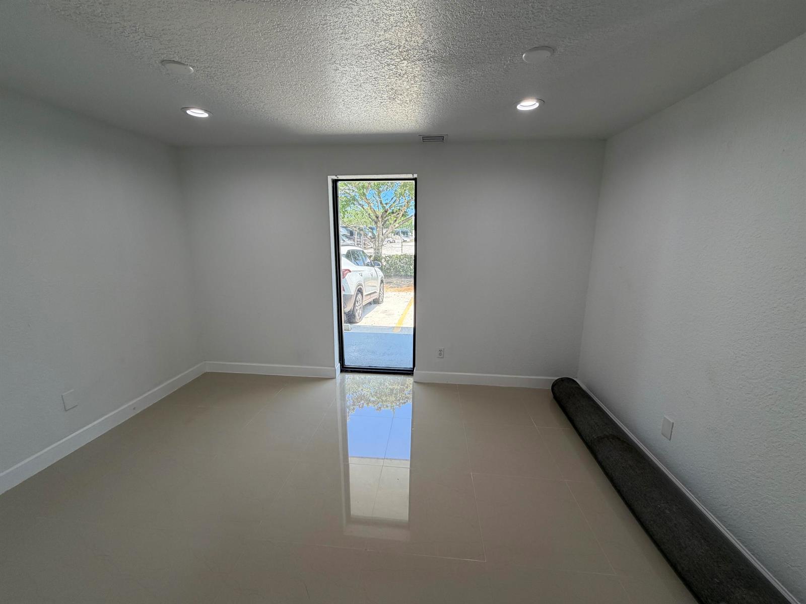 A staircase with dark treads and a white railing leads upward next to a wall painting — 500 Commerce Way Way W # 7, Jupiter FL 33458, JUPITER, FL