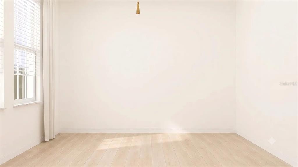 An empty room with light wood flooring, white walls, and a window with blinds — 6011 BLUE PALOMA, PALMETTO, FL