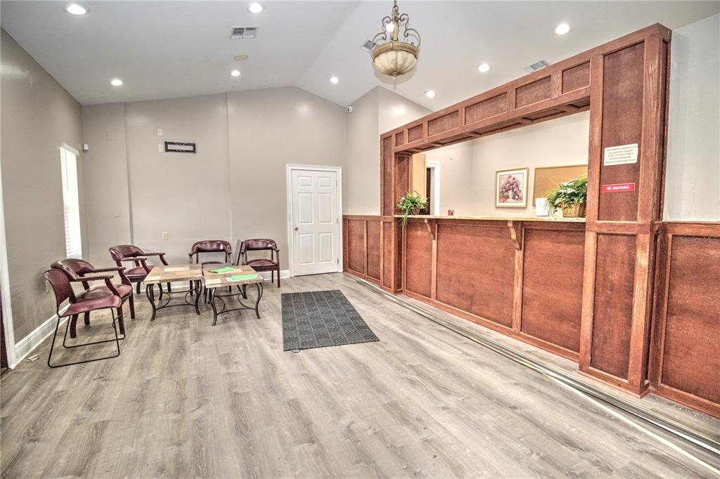 A waiting room features wood-paneled reception counters, vinyl flooring, and several chairs — 2131 SW 22ND PLACE UNIT 100, OCALA, FL
