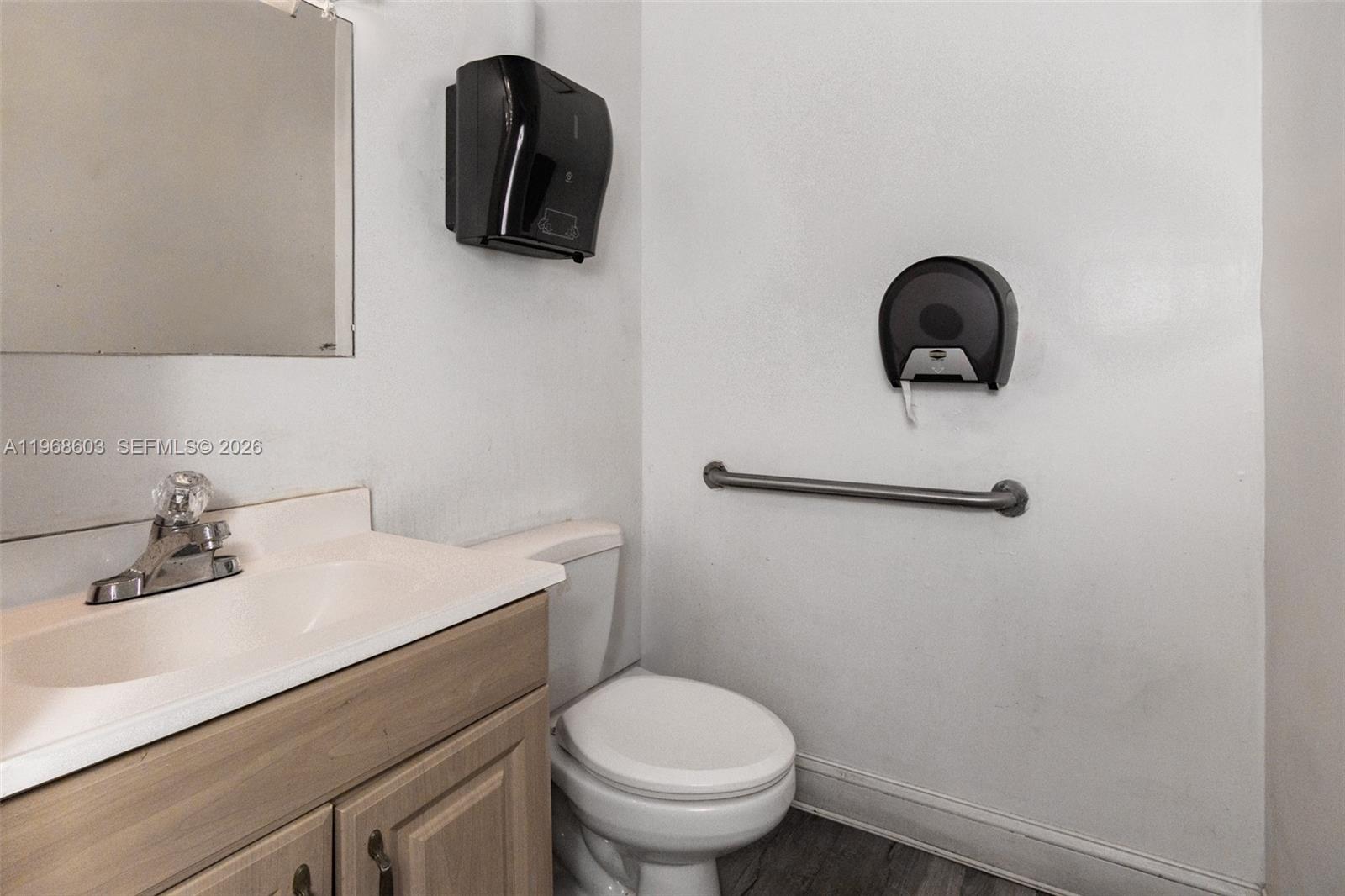 A bathroom features a vanity with a sink, a toilet, and a wall-mounted grab bar — 3337 NW 74th Ave # 3337, Miami FL 33122, MIAMI, FL
