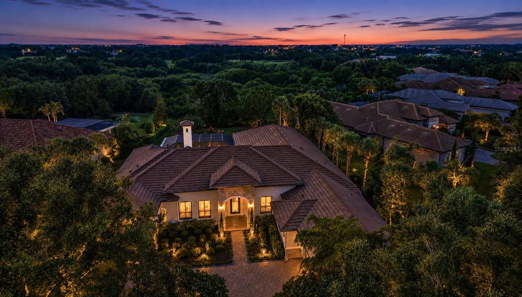 An aerial view of a large house with a tiled roof at sunset — 9261 MCDANIEL LANE, SARASOTA, FL