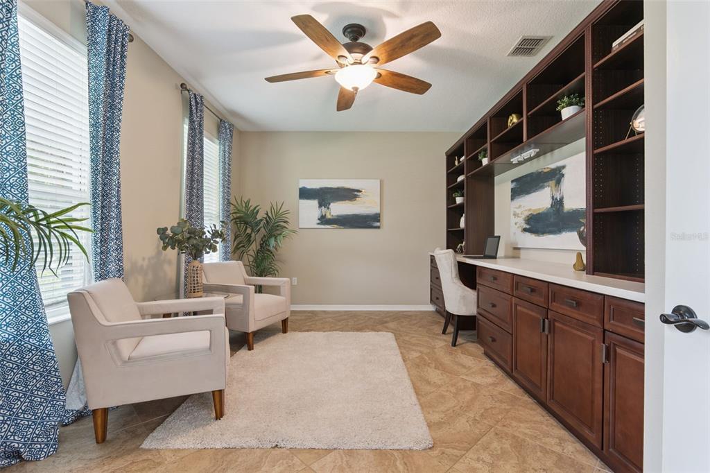 A home office features tile flooring, a built-in wooden desk with shelving, and two armchairs — 2226 PARKSIDE MEADOW DRIVE, APOPKA, FL