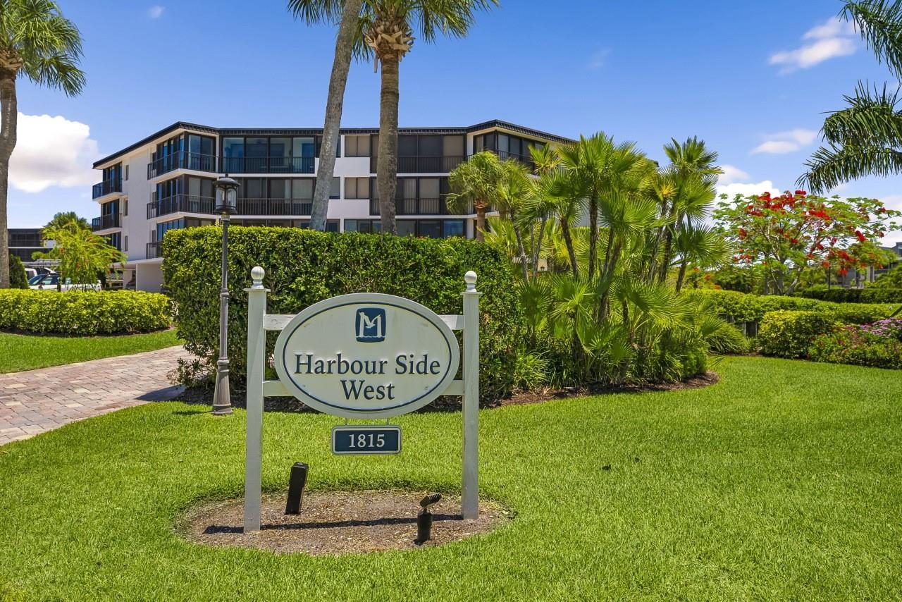 A sign for Harbour Side West stands on a grassy lawn in front of a building — 1815 Mooringline Drive # 2e, Vero Beach FL 32963, VERO BEACH, FL