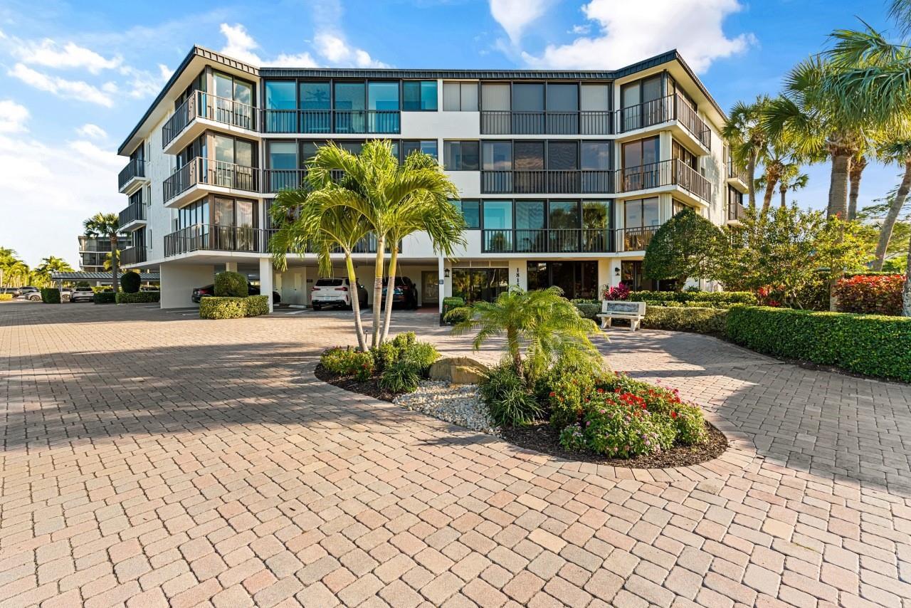 A multi-story apartment building with balconies and a paved parking area in front — 1815 Mooringline Drive # 2e, Vero Beach FL 32963, VERO BEACH, FL