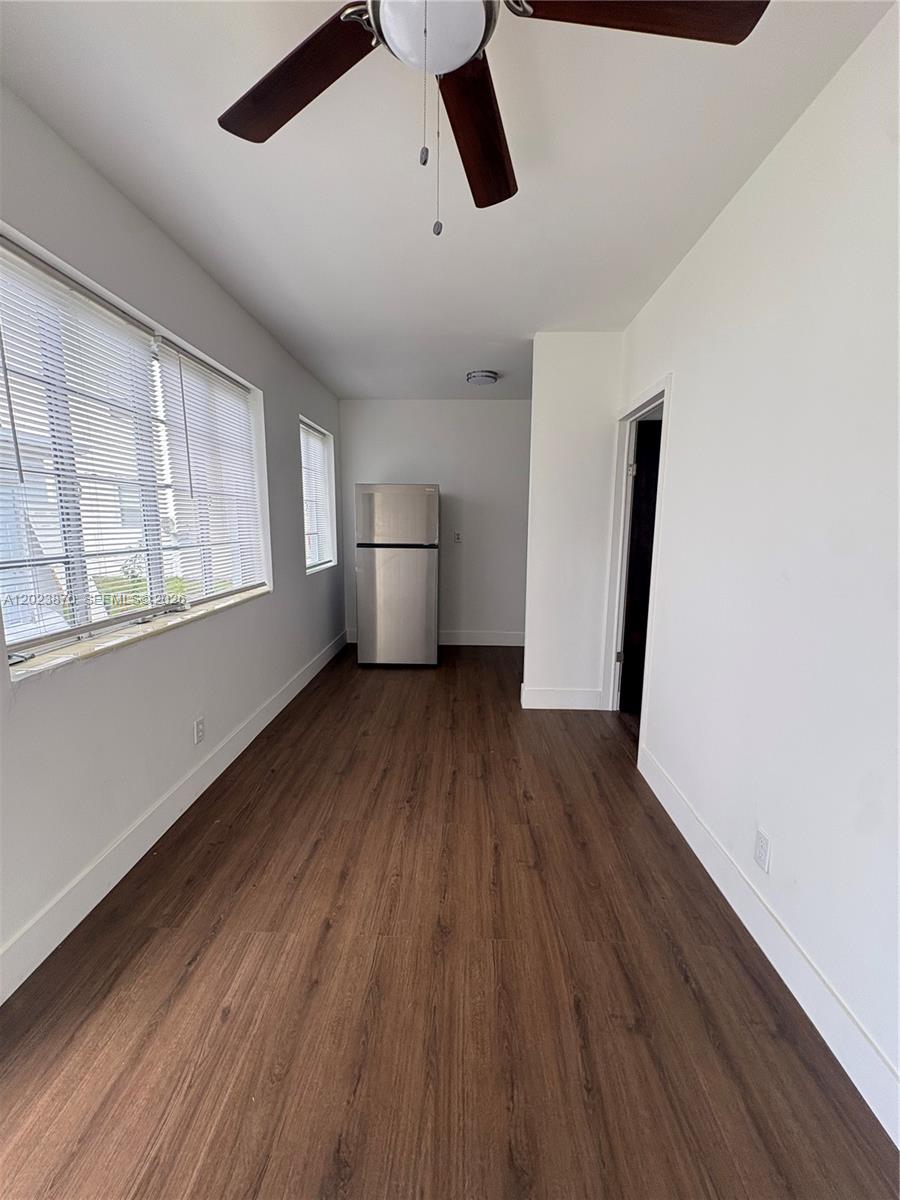 A narrow room features wood-look flooring, white walls, a ceiling fan, and a stainless refrigerator — 2052 SW 7th St # 4, Miami FL 33135, MIAMI, FL