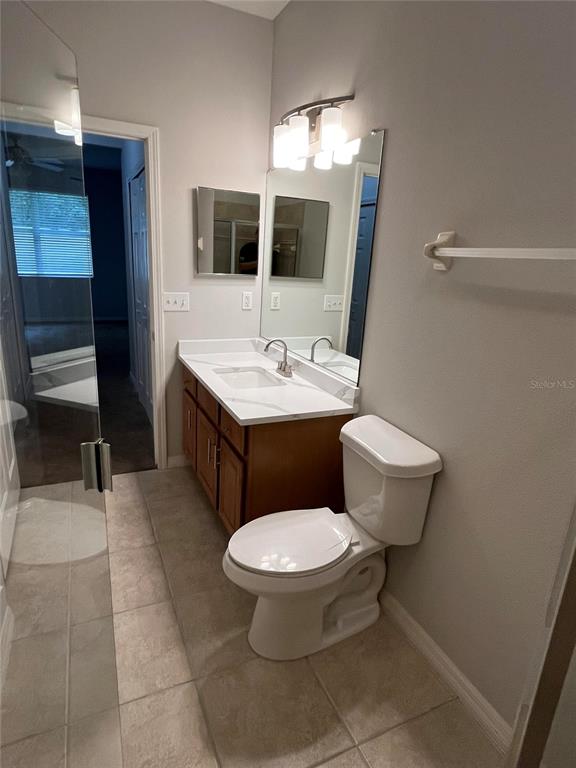 A kitchen features light-colored countertops, wood cabinets, stainless steel appliances, and a breakfast bar — 3635 PARKRIDGE CIRCLE UNIT 10-101, SARASOTA, FL