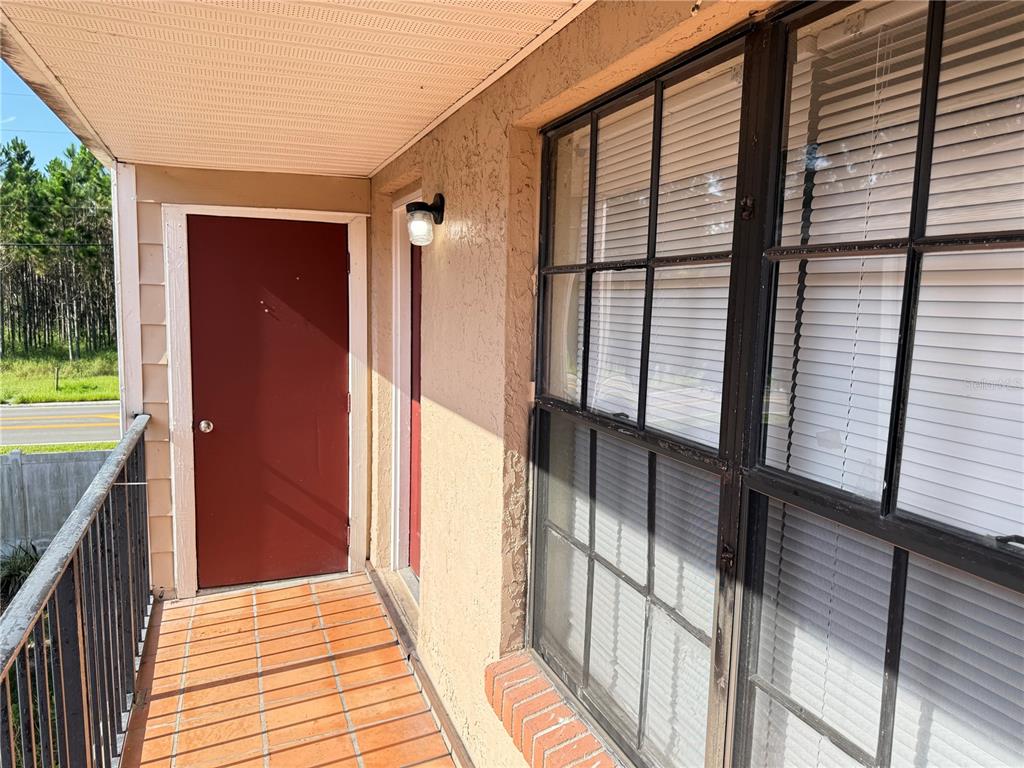A kitchen features light wood cabinets, granite countertops, stainless steel appliances, and a black refrigerator — 21026 VOYAGER BOULEVARD UNIT 6, LAND O LAKES, FL