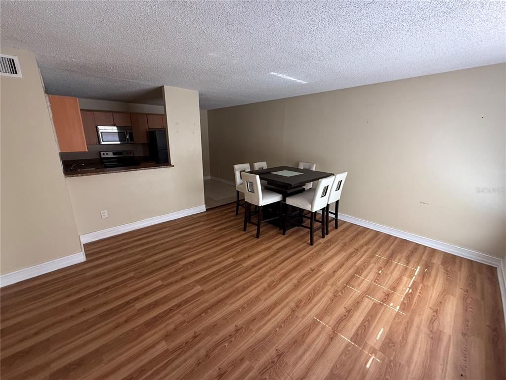 A bathroom features a tiled shower-tub combo, a white toilet, and a vanity with a sink — 21026 VOYAGER BOULEVARD UNIT 6, LAND O LAKES, FL