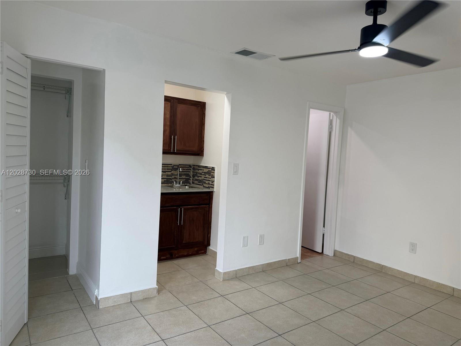 A room with tiled floors, a ceiling fan, a closet, and a small kitchenette — 19763 SW 124th Ave # 1, Miami FL 33177, MIAMI, FL