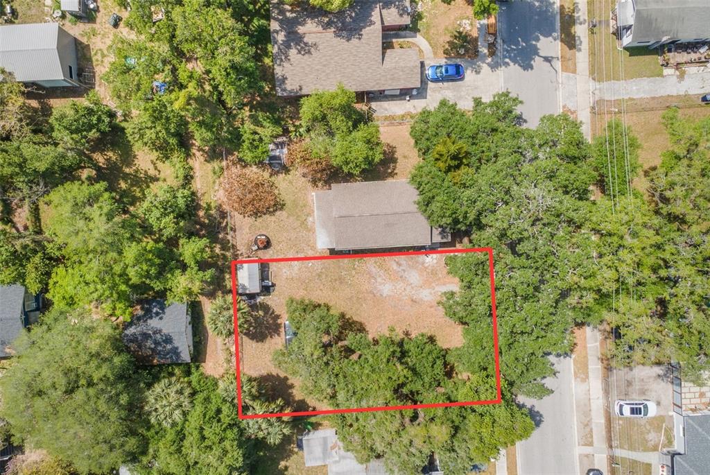 An aerial view shows a rectangular lot outlined in red next to a residential house — 1013 E 24TH AVENUE, TAMPA, FL