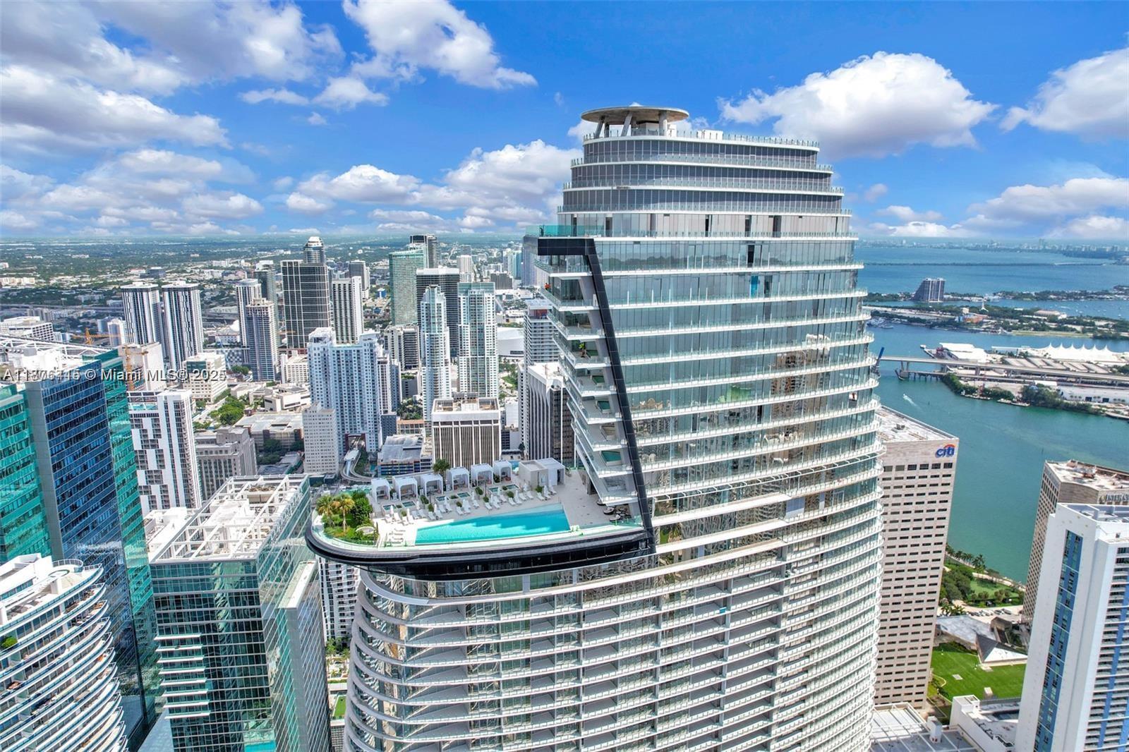 An aerial view of a modern skyscraper featuring a prominent cantilevered swimming pool and deck — 300 Biscayne Blvd Way # 2308, Miami FL 33131, MIAMI, FL