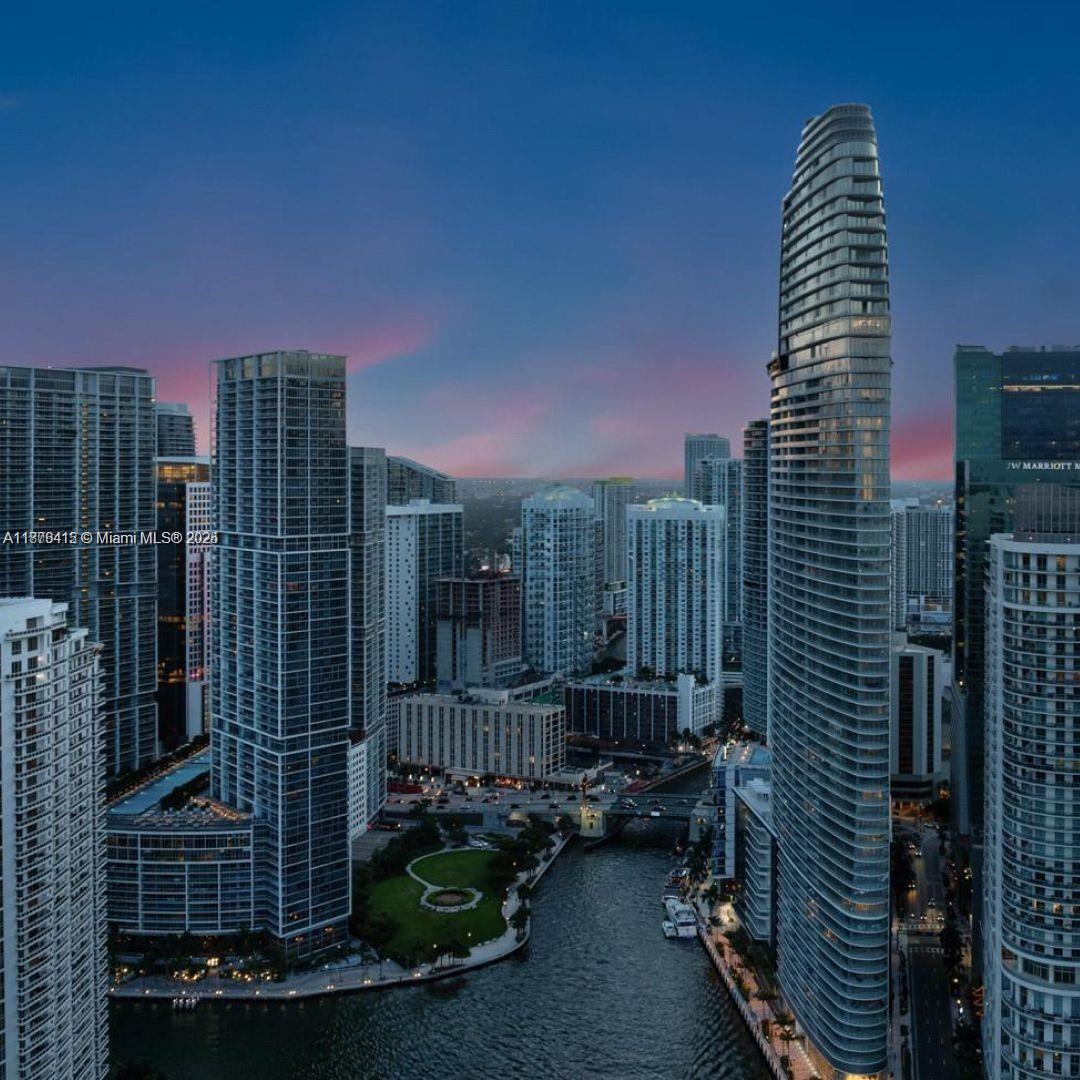An aerial view of the Miami skyline featuring high-rise buildings along a river at dusk — 300 Biscayne Blvd Way # 2308, Miami FL 33131, MIAMI, FL