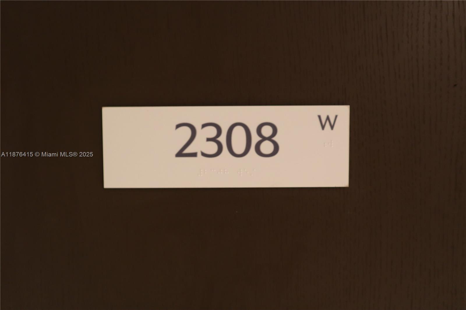 A rectangular sign with the number 2308 and the letter W is mounted on a door — 300 Biscayne Blvd Way # 2308, Miami FL 33131, MIAMI, FL
