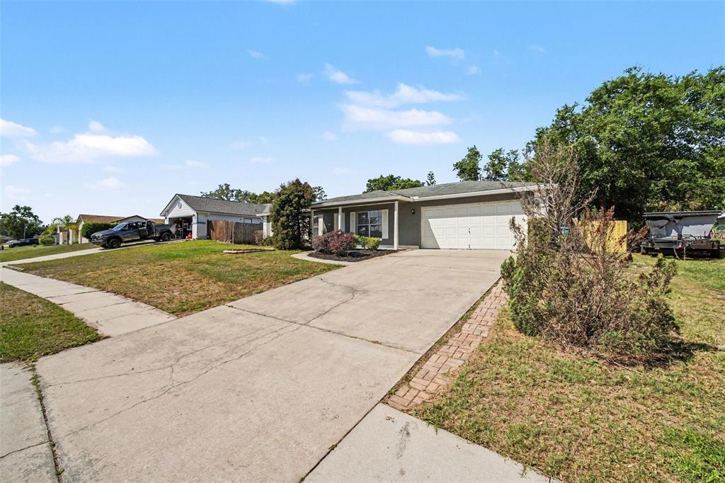 A single-story house with a white garage door and a concrete driveway — 756 SHAFTON AVENUE, DELTONA, FL