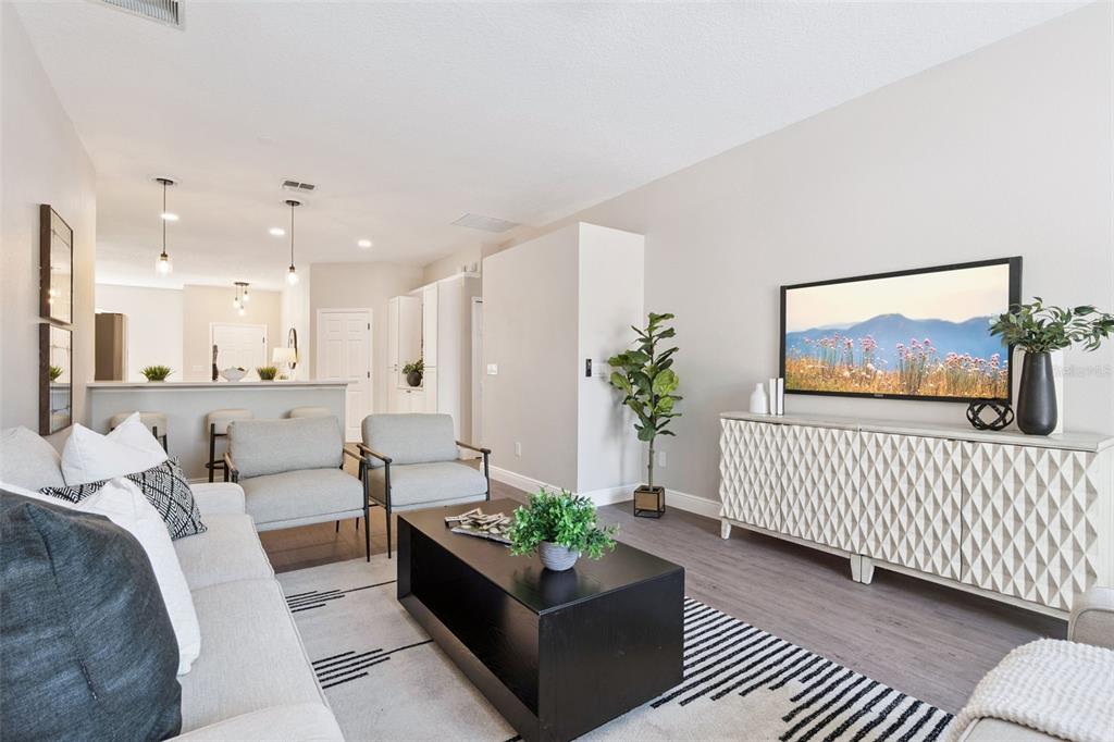 A living room features a sofa, two armchairs, a coffee table, and a television console — 1209 CATHCART CIRCLE, SANFORD, FL