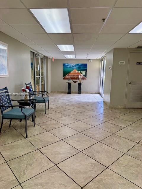 A waiting area features tile flooring, two chairs, and a landscape painting on the wall — 3910 Inverrary Blvd # B, Lauderhill FL 33319, LAUDERHILL, FL