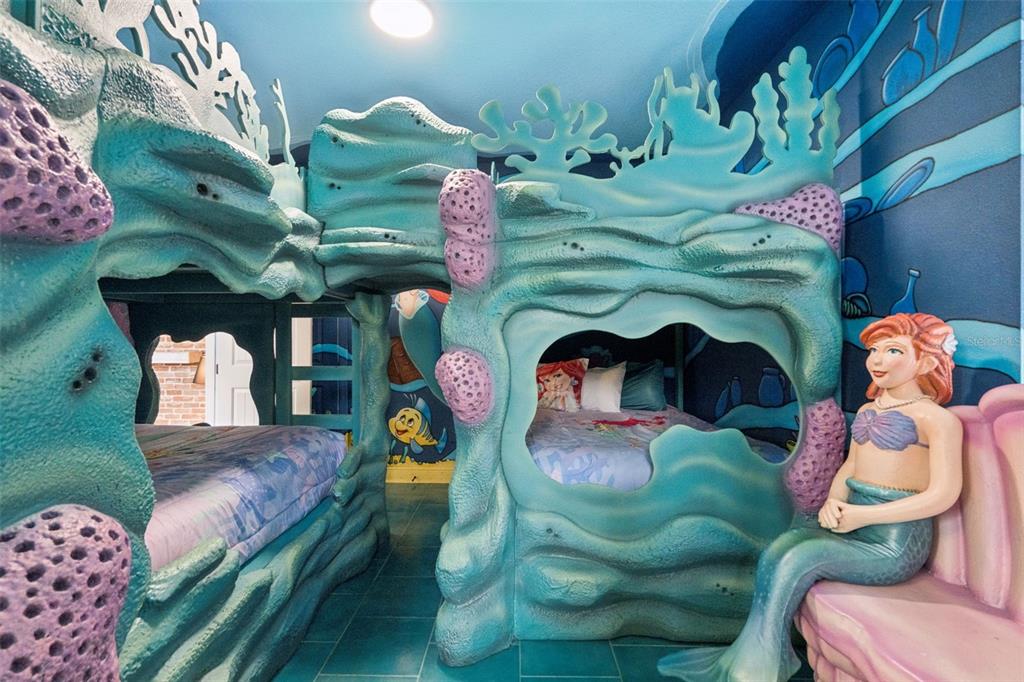 A themed bedroom features custom bunk beds designed to look like an underwater coral reef — 7605 BROOKHURST LANE, KISSIMMEE, FL