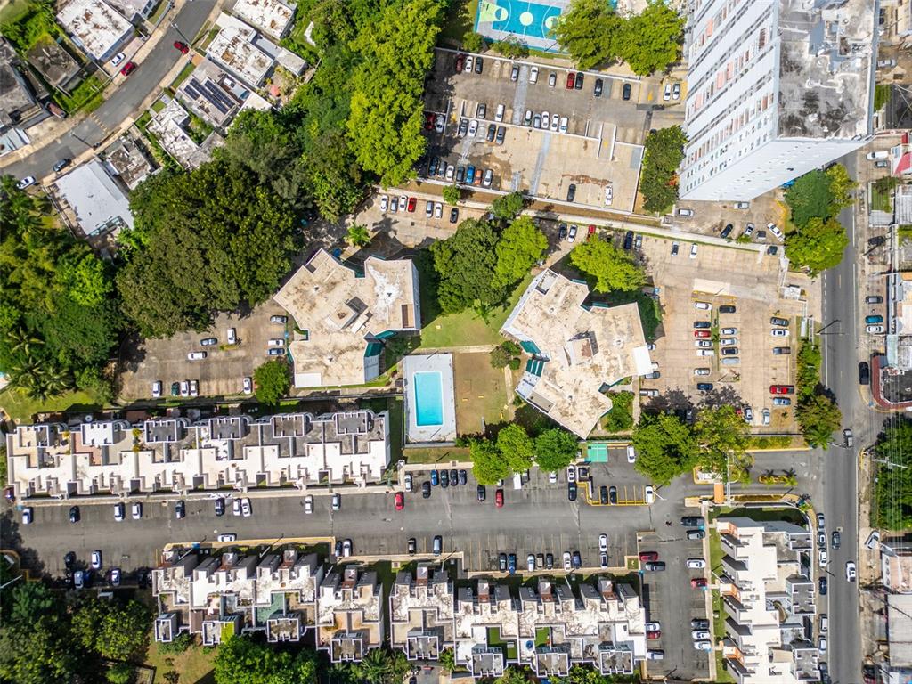 Aerial view of a residential complex featuring apartment buildings, a swimming pool, and parking lots — 472 CALLE DE DIEGO UNIT 602 B, SAN JUAN, PR