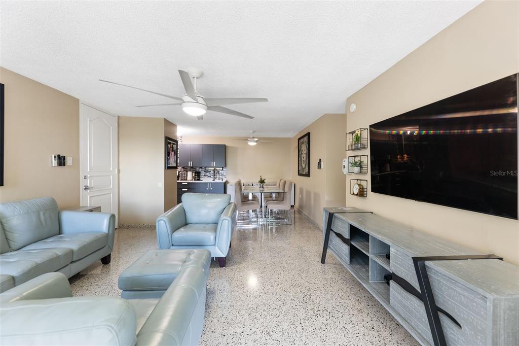 A living room with light blue leather furniture, a large television, and terrazzo flooring — 472 CALLE DE DIEGO UNIT 602 B, SAN JUAN, PR
