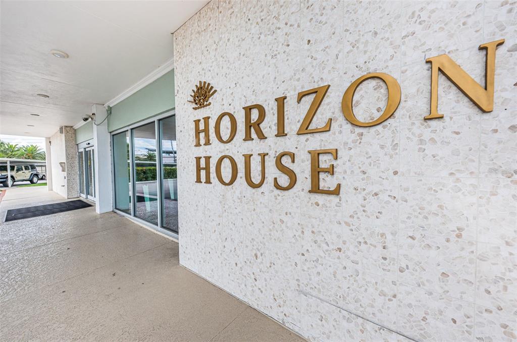 The exterior entrance of a building features a terrazzo wall with gold Horizon House lettering — 31 ISLAND WAY UNIT 605, CLEARWATER BEACH, FL
