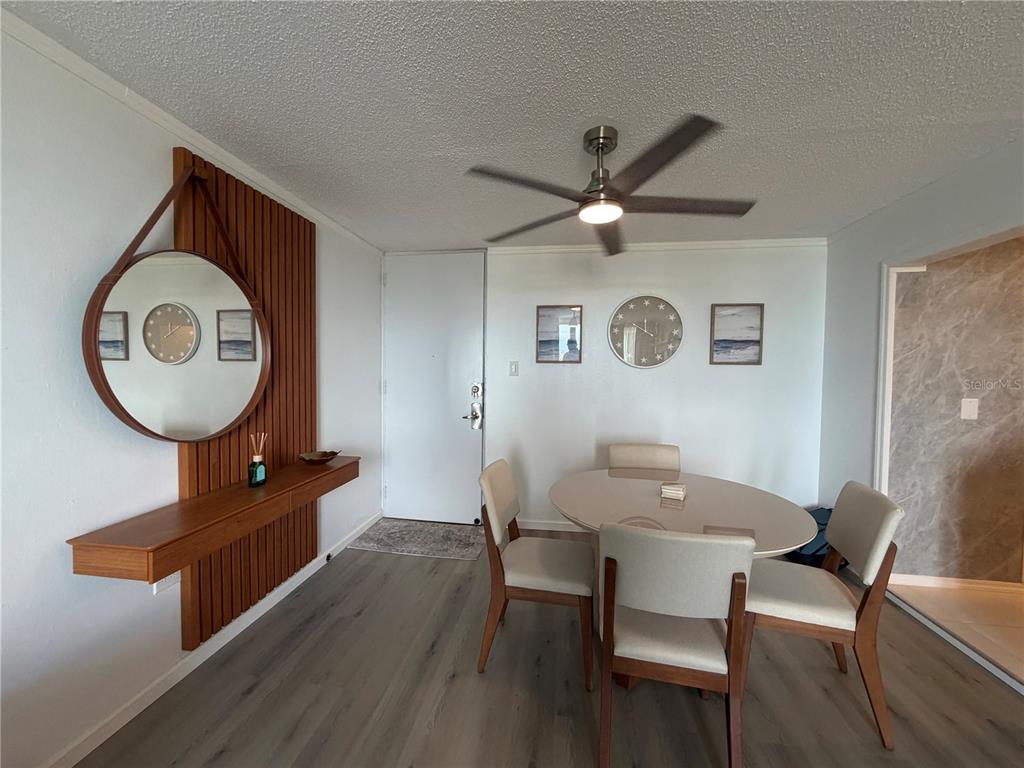 A dining area features a round table, four chairs, a wall-mounted shelf, and a mirror — 190 MARGINAL LOS ANGELES UNIT 8, CAROLINA, PR
