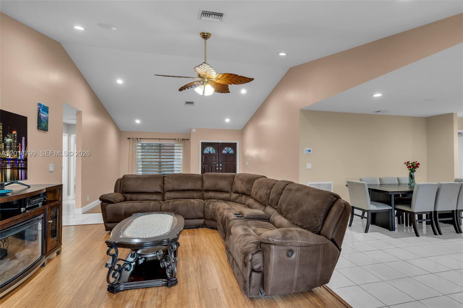 A living room features a brown sectional sofa, a coffee table, and a ceiling fan — 7817 Sunflower Dr, Margate FL 33063, MARGATE, FL