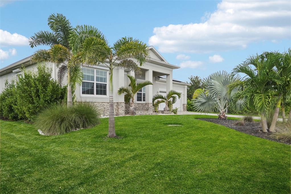 A single-story house with a stone-accented facade and palm trees in the front yard — 15301 CHINOOK WAY, PORT CHARLOTTE, FL