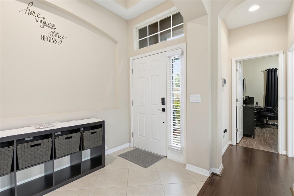 A multi-purpose room with hardwood floors, a desk area, and two stationary exercise bikes — 11105 WEMBLEY LANDING DRIVE, LITHIA, FL