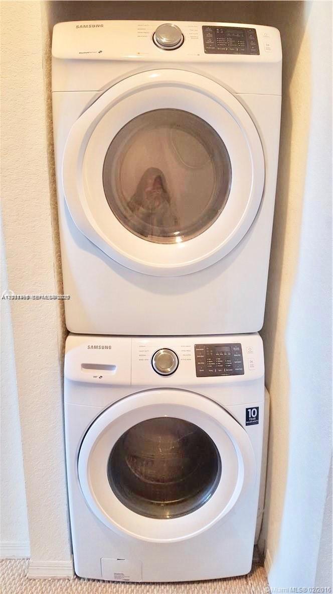 A stacked Samsung washer and dryer unit are installed in a narrow wall alcove — 14055 SW 49th St # 6, Miramar FL 33027, MIRAMAR, FL