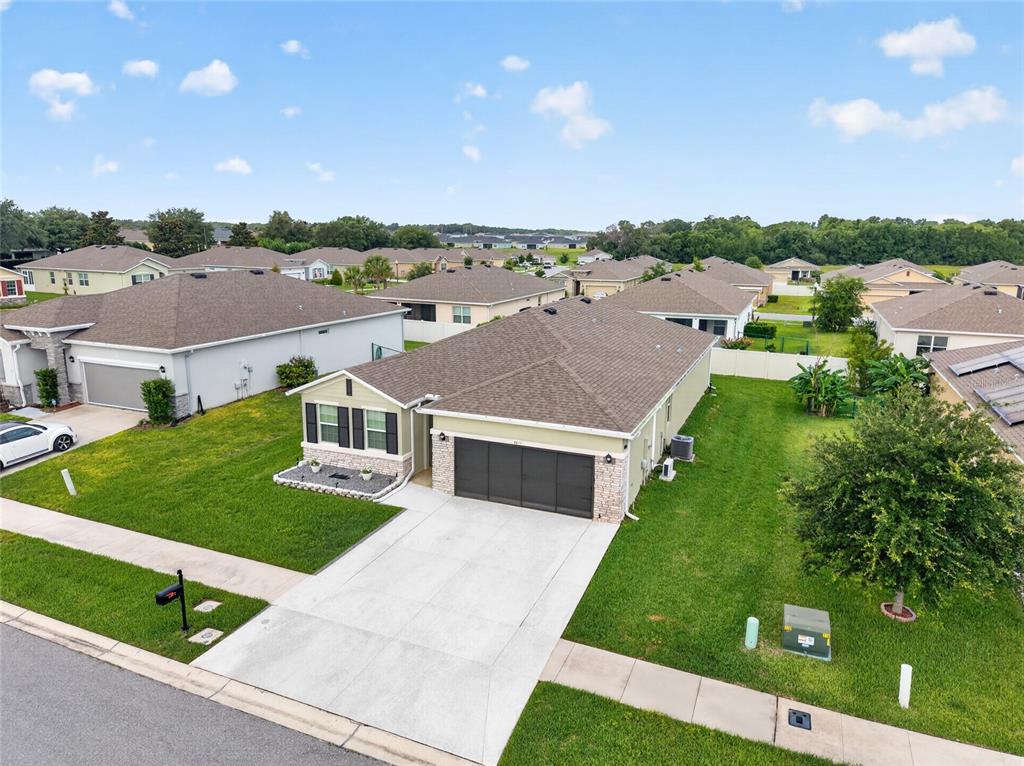 An aerial view of a single-story suburban house with a garage and a grassy yard — 8872 SW 63RD AVENUE, OCALA, FL
