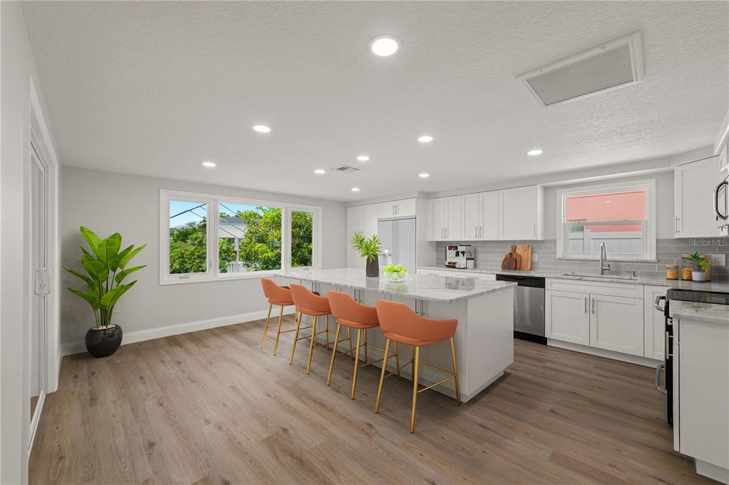 A single-story house with a dark garage door, a palm tree, and a sunset sky — 6617 HARBOR DRIVE, HUDSON, FL