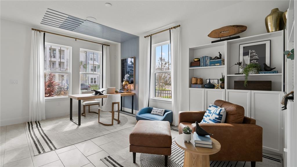 A home office features a desk, a leather armchair with ottoman, and built-in shelving units — 15213 GROVESIDE ROAD, WINTER GARDEN, FL