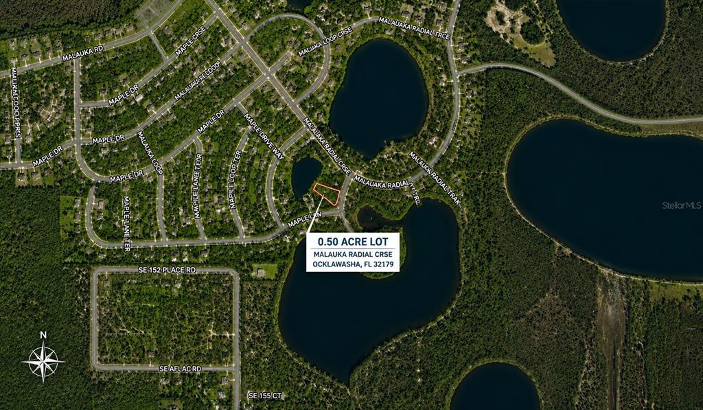 This is an aerial map showing a vacant lot highlighted in red near a lake — 0 MALAUKA RADIAL CRSE, OCKLAWAHA, FL
