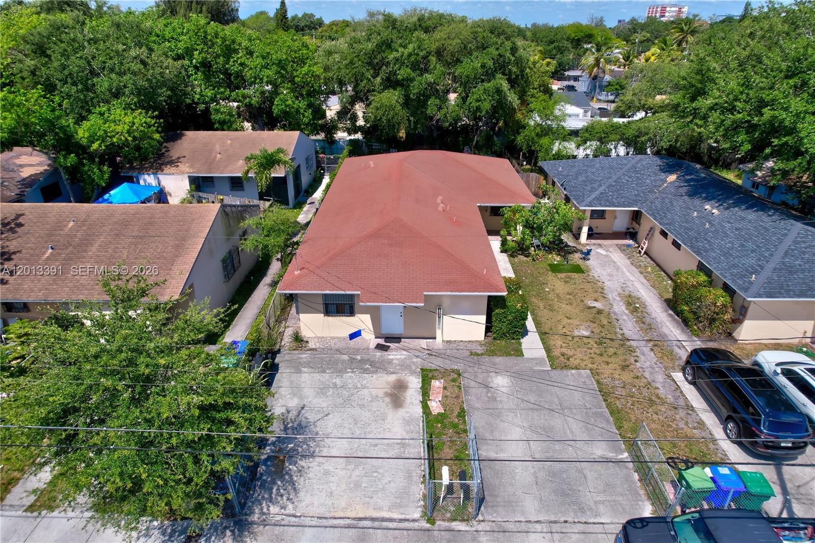 An aerial view shows a single-story house with a red roof and a concrete driveway — 7628 NW 2nd Ct, Miami FL 33150, MIAMI, FL
