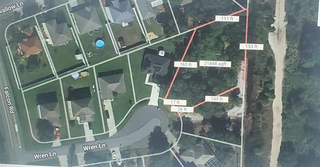 This is a map showing the property boundaries and dimensions of a residential lot — 709 WREN LANE, POINCIANA, FL