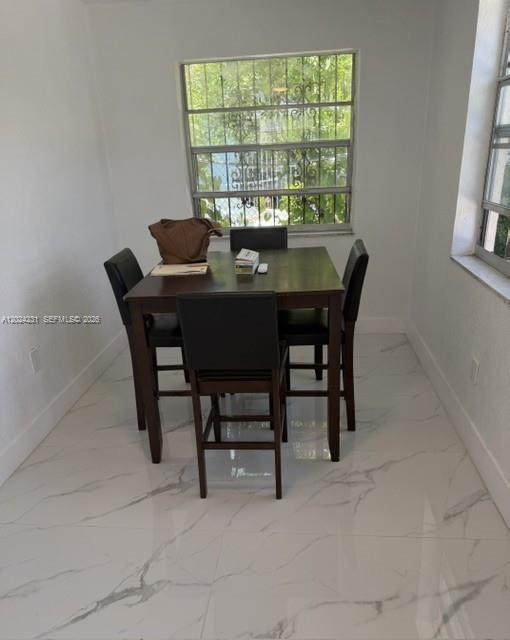 A kitchen with gray cabinets, white countertops, a white stove, and white marble-patterned tile flooring — 262 NE 55th Ter # 0, Miami FL 33137, MIAMI, FL