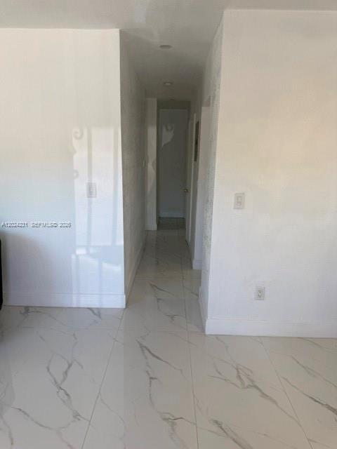 A bathroom features white marble-patterned wall and floor tiles, a toilet, and a walk-in shower — 262 NE 55th Ter # 0, Miami FL 33137, MIAMI, FL