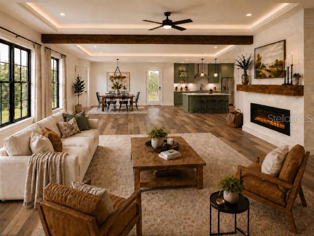 An open-concept living room and kitchen feature wood flooring, a fireplace, and a coffered ceiling — 6801 BALSAM PLACE, SEBRING, FL