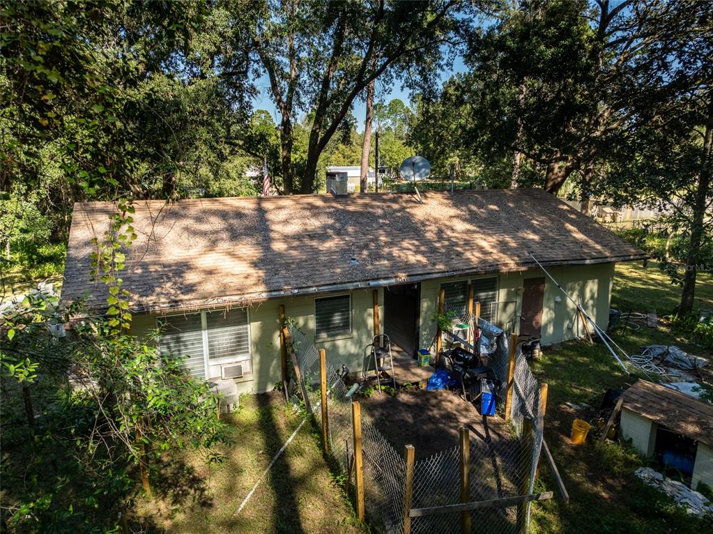 An aerial view of the back of a single-story house with a fenced yard — 27726 LUELLA AVENUE, PAISLEY, FL