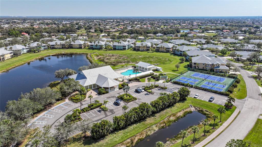 An aerial view shows a community clubhouse with a pool, tennis courts, and parking lot — 2061 WILLOW HAMMOCK CIRCLE UNIT 105, PUNTA GORDA, FL