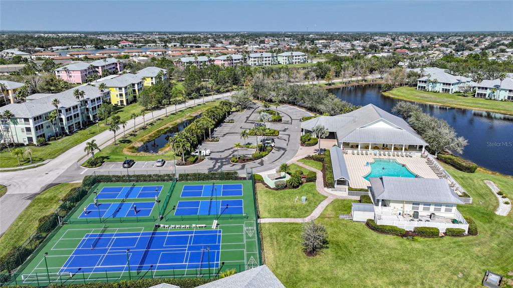 An aerial view shows a residential complex with tennis courts, a swimming pool, and parking — 2061 WILLOW HAMMOCK CIRCLE UNIT 105, PUNTA GORDA, FL