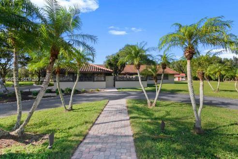 An aerial view shows a house with a red tile roof, tennis court, and barn — 3761 Dellwood Blvd., Loxahatchee FL 33470, LOXAHATCHEE, FL