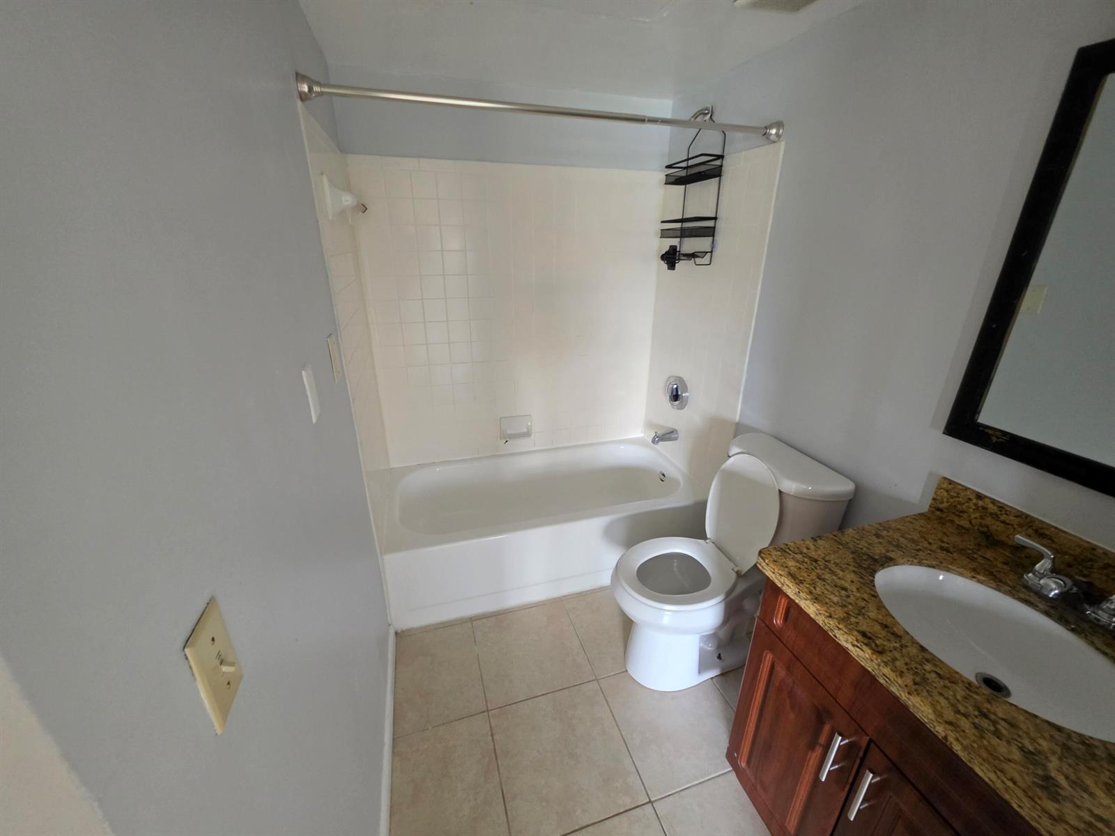A bathroom features a tub-shower combination, a toilet, and a vanity with a granite countertop — 18340 NW 68th Avenue # F, Hialeah FL 33015, HIALEAH, FL