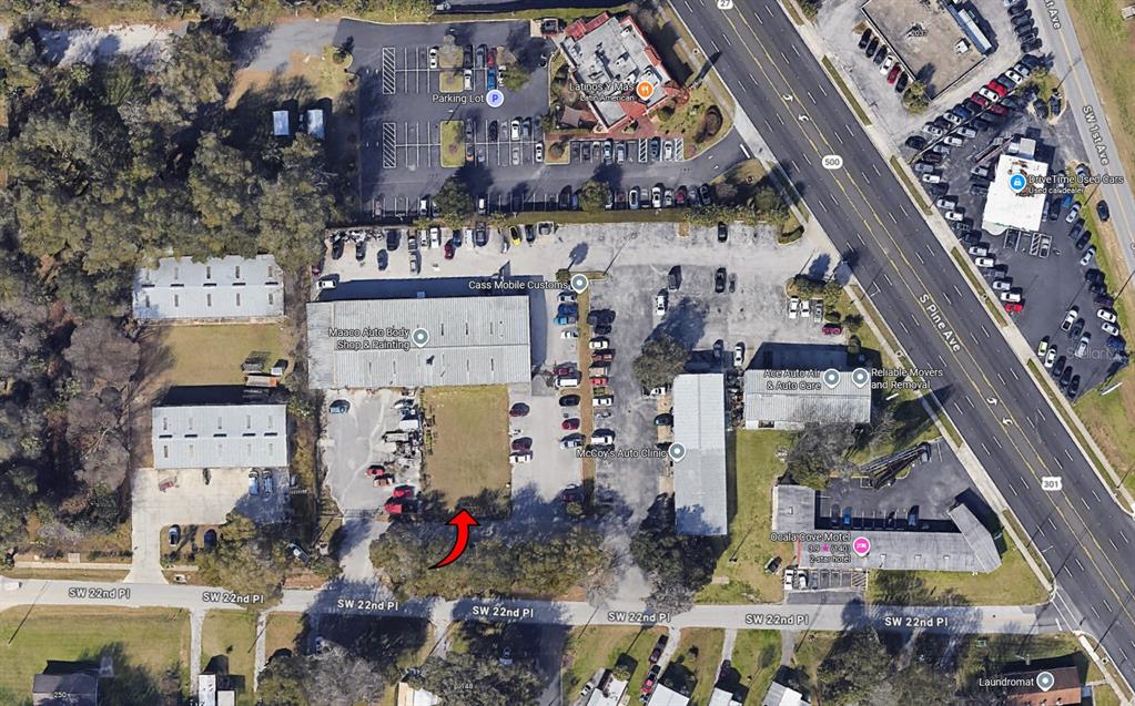 This aerial map shows a commercial property with several buildings and parking lots — SW 22 PLACE, OCALA, FL