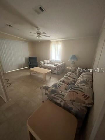 A living room features tile flooring, a ceiling fan, and two patterned sofas — 232 NESBITT PARK AVENUE, DAVENPORT, FL