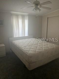 A bedroom features a mattress on a box spring, a ceiling fan, and a window — 232 NESBITT PARK AVENUE, DAVENPORT, FL