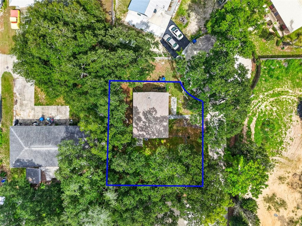 An aerial view shows a house surrounded by trees within a blue property boundary line — 1454 HOWARD STREET, GROVELAND, FL