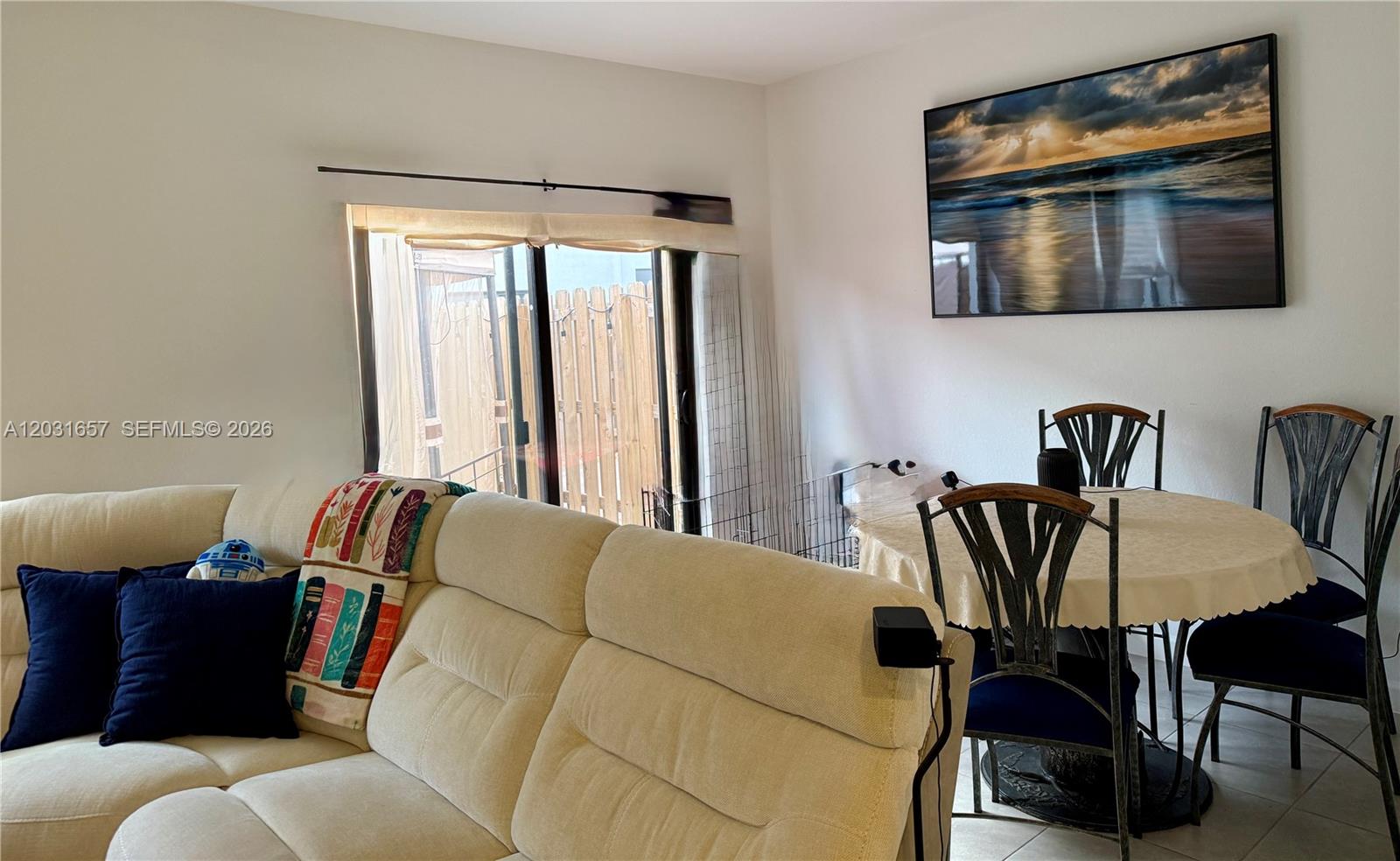 A living and dining area features a beige sectional sofa, a round table, and artwork — 23049 SW 129th Pl, Miami FL 33170, MIAMI, FL