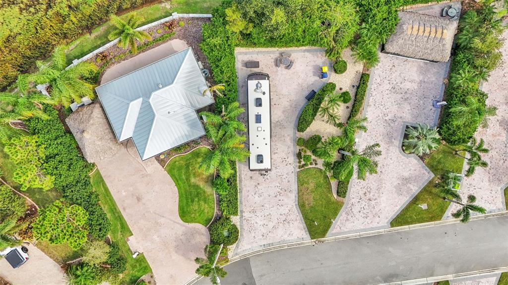 An aerial view shows a house with a metal roof, a parked RV, and landscaping — 3166 GREAT HERON LOOP, POLK CITY, FL